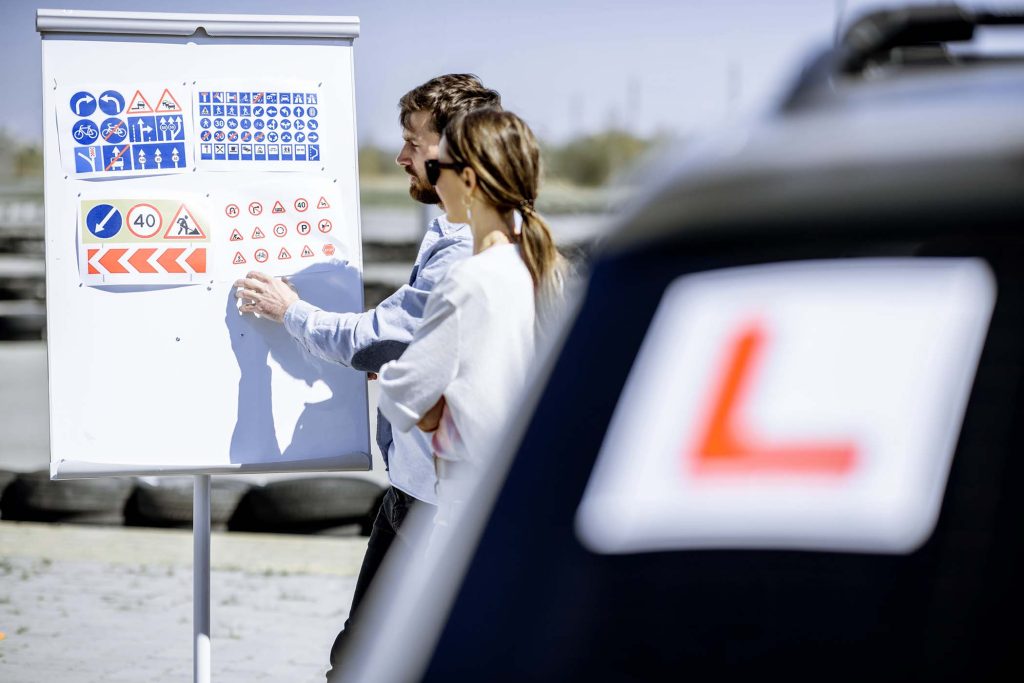 driver-instructor-with-student-on-the-training-gro-ENAUHMC.jpg